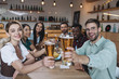 © LIGHTFIELD STUDIOS - cheerful multicultural friends holding glasses of light beer and smiling at camera