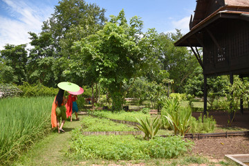 Kanchanaburi, Thailand, 09.09.2019: Beautiful garden, lake, traditional Thai, Siamese clothes, buildings of 