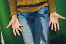 Low Section View Of Person's Wet Jeans Standing On Carpet.