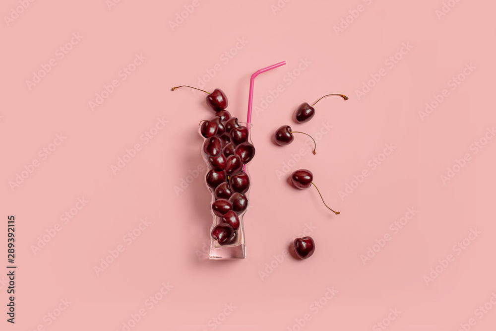 Cherry in a glass on a pastel background. Minimal Berry Juice Concept - obrazy, fototapety, plakaty 