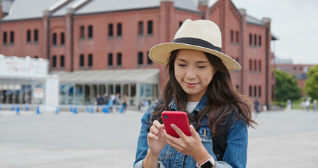 Poster - Woman use of cellphone in Yokohama Red Brick Warehouse