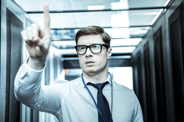 Wall Mural - Young professional in a blue shirt pointing to a problematic place