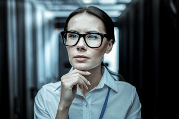 Wall Mural - Dark-haired professional from intelligence agency in eyeglasses looking thoughtful