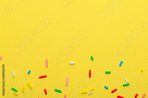 colorful sprinkles over yellow background, decoration for festive Valentines ...