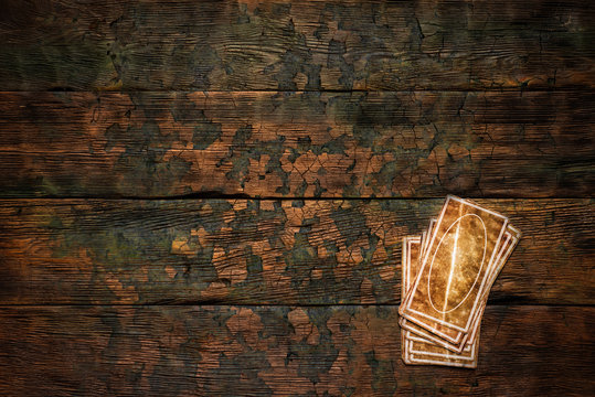 deck of tarot cards on the wooden table. divination concept.