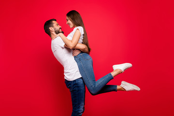 Wall Mural - Profile side view portrait of his he her she nice attractive lovely lovable affectionate cheerful careful spouses spending honey moon vacation having fun isolated on bright vivid shine red background