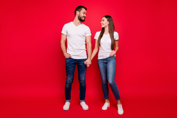 Poster - Full length body size view of his he her she nice attractive lovely affectionate tender sweet cheerful cheery married spouses life partners holding hands isolated on bright vivid shine red background