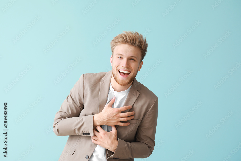 Happy young man on color background