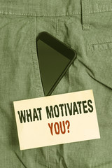 Word writing text What Motivates Youquestion. Business photo showcasing know reasons why you want to wake up each morning Smartphone device inside formal work trousers front pocket near note paper