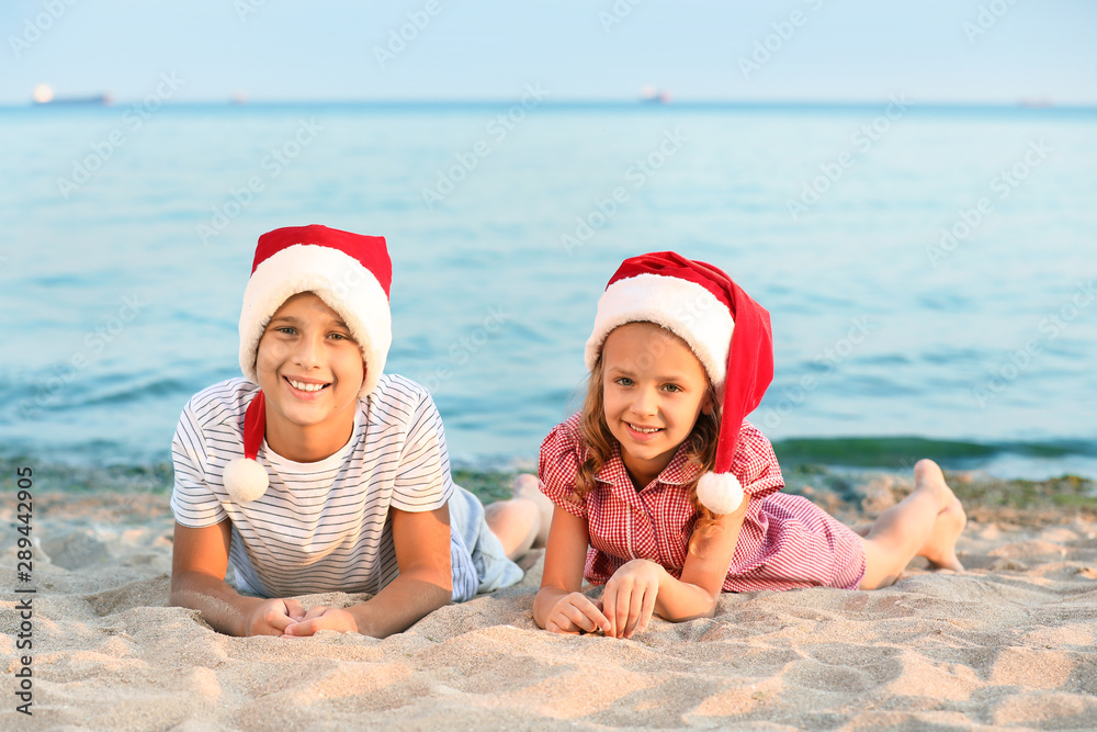 Happy children celebrating Christmas at tropical resort