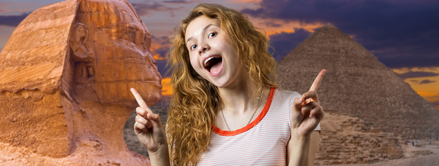 Wall Mural - The girl is happy from visiting Egypt. Giza pyramids in Cairo behind the back of a beautiful lady.