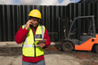 © Wavebreak Media - Forklift driver using smartphone and tablet outside factory warehouse