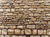 Fototapeta Desenie - yellow stone wall of italy old town