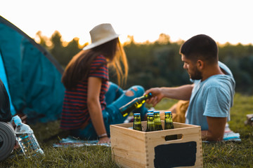 Wall Mural - friends drinking beer on camping outdoor by the river