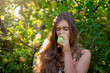© NatBud - Girl in the apple orchard eating an apple. Autumn fruit picking. Young girl with long hair. Balanced Nutrition, Vegetarianism