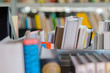 © CrispyMedia - Books in a book shelf in the library. Selection of literature, preparing for exams