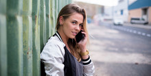 Beautiful Woman Or Teenager Talking With Her Boyfriend Or Friends With Her Phone On A Urban Stret Looking At The Orizont