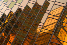 Golden Building. Windows Glass Of Modern Office Skyscrapers In Technology And Business Concept. Facade Design. Construction Structure Of Architecture Exterior For Urban Cityscape Background.