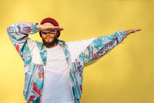 Stylish Young Hipster Man With Beard In Red Hat And A Retro Jacket Of 90s On Yellow Background.Crazy Hipster Guy Emotions. Collage In Magazine Style 