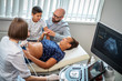 © Nejron Photo - Pregnant woman and her family on utltrasonographic examination at hospital