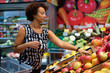 © Nejron Photo - Pretty black woman choosing fruits in a grocery store