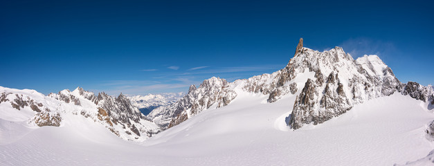 Wall Mural - panorama of the snow covered glacier on top of the mont blanc massif between italy and france, the h