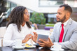 © Mangostar - Serious excited business colleagues discussing project and arguing. Diverse business man and woman sitting in cafe, using tablet together and talking. Teamwork concept