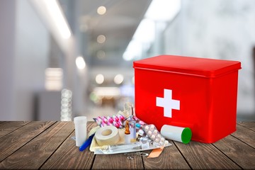 Poster - First aid kit  with medical supplies on light background