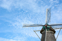Old Dutch Windmill From The Year 1776 With Blue Cloudy Sky And Flying Birds, Zwolle, The Netherlands