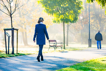 Wall Mural - middle-aged woman walking in city park