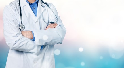 Wall Mural - Portrait of doctor with stethoscope on blurred background