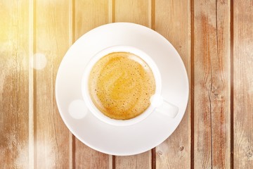 Wall Mural - Cup of coffee on wooden background