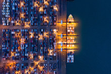 Aerial Top View Of Container Cargo Ship In The Export And Import Business And Logistics International Goods In Urban City. Shipping To The Harbor By Crane In Victoria Harbour, Hong Kong City At Night.