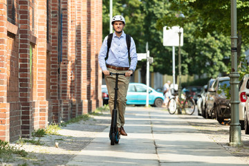 Young Man Riding An Electric Scooter