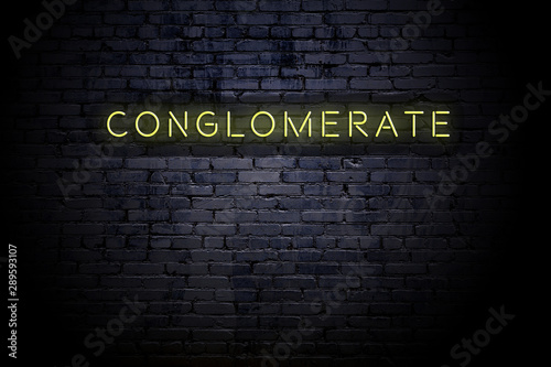 Cuadros en Lienzo Highlighted brick wall with neon inscription conglomerate