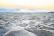 Low Depth Of Field Beach Landscape Sand Surf And Sunset In View