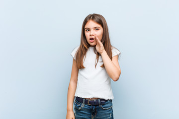 Wall Mural - Cute girl is saying a secret hot braking news and looking aside