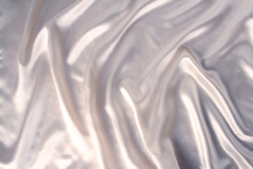 soft folds on delicate white shiny silk, luxury concept, background for the designer, horizontal, close-up, copy space