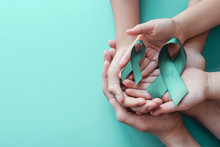 Adult And Children Hands Holding Teal Ribbons On Blue Background, Ovarian Cancer, Cervical Cancer, Anti Bullying And Sexual Assault Awareness