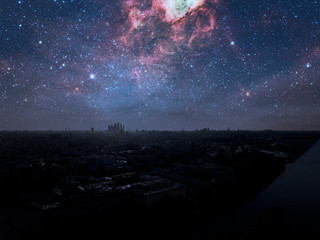 night sky with many stars over urban city landscape