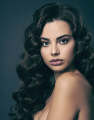 Poster - Beautiful young woman with long curly brown hair