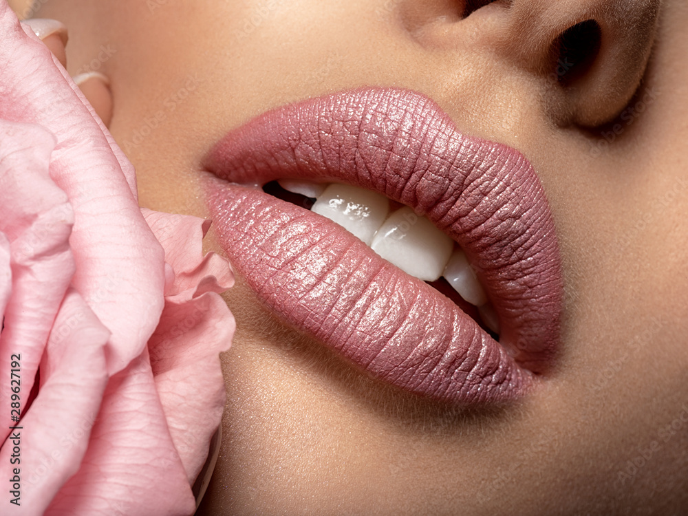 Closeup sexy female lips with pearl lipstick. Women's lips and pearl flower - obrazy, fototapety, plakaty 