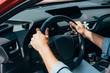 © LIGHTFIELD STUDIOS - cropped view of young adult man sitting in car