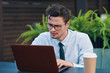 © SHOTPRIME STUDIO - young man working on his laptop in park