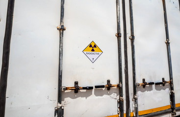 Wall Mural - Radiation warning sign on the Dangerous goods transport label Class 7 at the container of transport truck