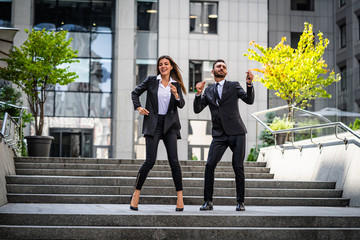 Wall Mural - The man and woman in suits dancing near a business center