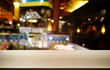 © Charlie's - Empty dark wooden table in front of abstract blurred bokeh background of restaurant . can be used for display or montage your products.Mock up for space.