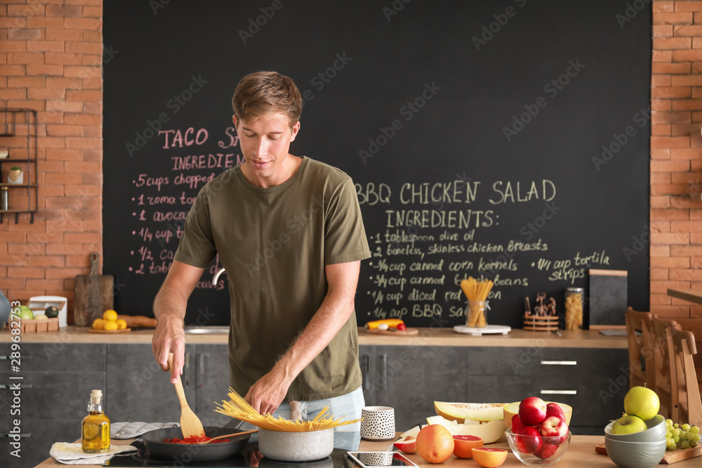 Handsome man cooking in kitchen