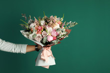 Man Holding Beautiful Flower Bouquet On Green Background, Closeup View. Space For Text
