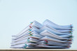© JC_STOCKER - Stack of document paper with colorful paperclip place on wooden table with copy space.